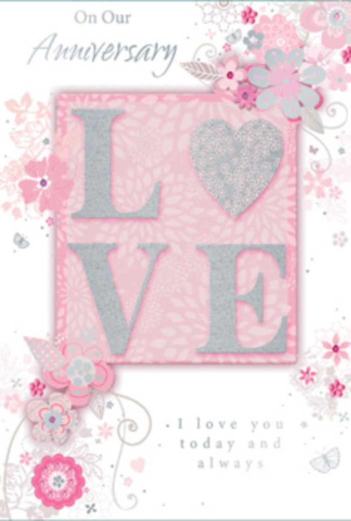This detailed view of an anniversary card feels like opening the door to a sun-filled room in Ruislip where love is quietly, consistently celebrated. At the heart of the design, the word LOVE is printed in an elegant, frosted glitter finish, with each letter raised slightly from the surface. The texture suggests a soft, almost velvety feel beneath the fingers, catching the light with a subtle sparkle similar to early morning reflections on the water at Ruislip Lido. Around this central motif, wispy, hand-drawn blooms and sprays of foliage drift along the edges of the card, creating a gentle border. The flowers are coloured in soft shades of pink, lilac, and ivory, blending into one another as though sketched and then gently washed with watercolour. Fine flourishes weave between the blossoms-slender filigree lines, tiny leaves, and small, almost-hidden butterflies that seem to hover in mid-air. These elements suggest movement and quiet joy, like a warm breeze passing through the gardens of local Ruislip homes. Near the centre, the message I love you today and always appears in graceful, understated lettering, balanced so it feels calm and sincere rather than showy. The background remains softly tinted, allowing the pastel flowers and glittered letters to stand out without harsh contrast. Together, the design reads as a paper version of a hand-tied bouquet: romantic, delicately arranged, and filled with thought. It is easy to imagine this card paired with fresh anniversary flowers from a nearby Ruislip florist, placed lovingly on a kitchen table ready to greet a partner at the start of a special day.